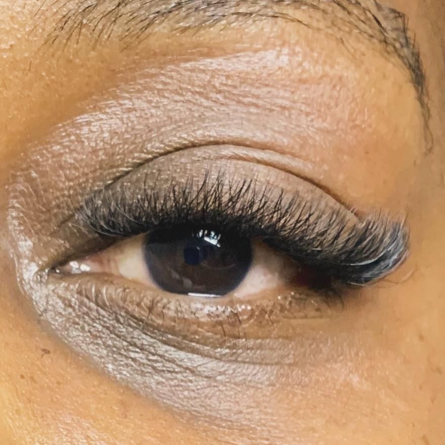Close-up of a finished set of lash extensions, applied one at a time along the natural lash line.